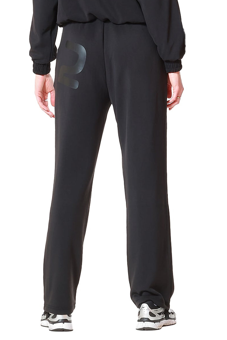 Person wearing a black tracksuit on a white background